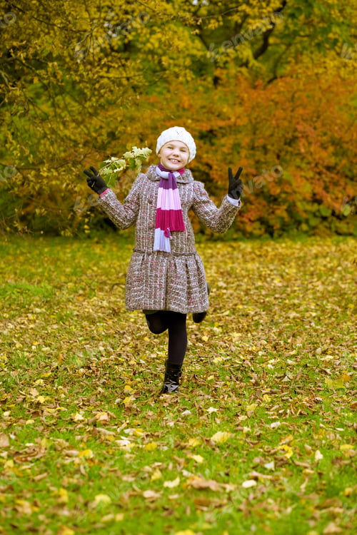 Preview: Young Funny Little Cute Girl Havng Fun In Autumn Park Standing With Lifted Hands
