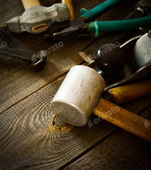 Preview: The Old Working Tool. Many Old Working Tools ( Mallet, Pliers And Others) On A Wooden Background.