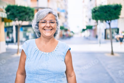 Preview: Smiling Woman with Gray Hair on City Street