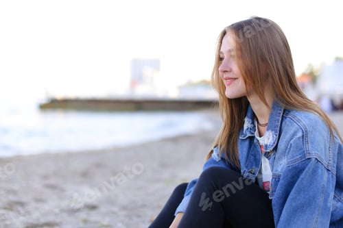 Preview: Smiling Young Woman Relaxing on Beach
