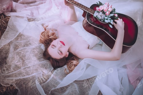Preview: Beautiful Romantic European Girl With Guitar With Flowers Inside, Posing Outdoors. Concept Of Music