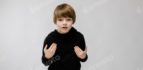 Preview: Portrait Of Adorable Surprised Little Boy Standing In Studio On Grey Background