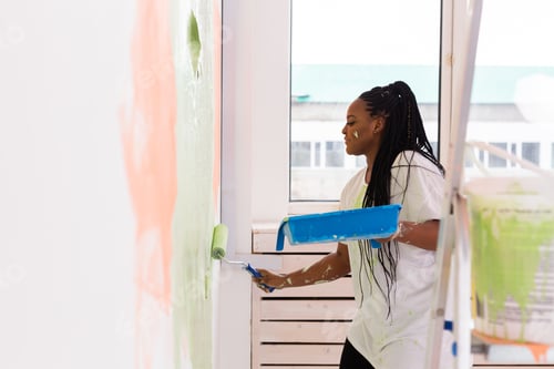 Preview: Happy African American Woman Painting Wall In Her New Apartment. Renovation, Redecoration And