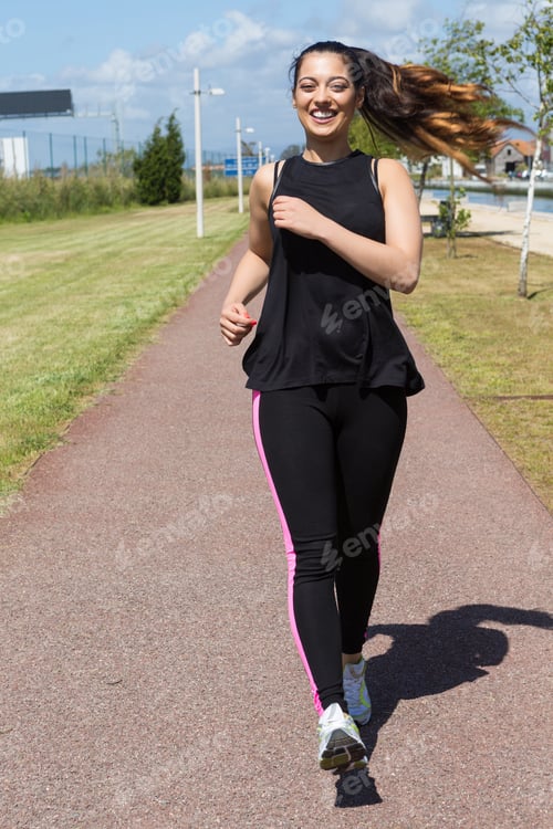 Preview: A Beautiful Young Woman Making Some Exercise At The Park - Fitness Concept