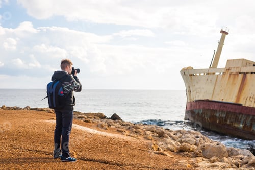Preview: Young Photographer On The Beach. Traveler Photographer With Digital Camera.
