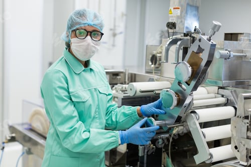 Preview: Caucasian Factory Worker In Blue Lab Suit Check Readings Of Manufacture Machine, Look At Camera