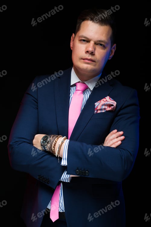 Preview: Portrait Of Confident Handsome Businessman With Crossed Arms On Black Background