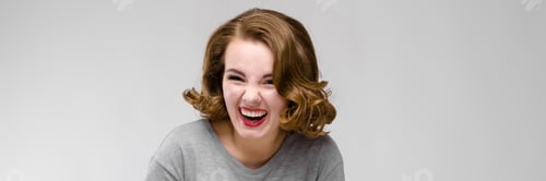 Preview: Charming Young Girl In A Gray T-Shirt On A Gray Background. The Girl Leads A Dialogue