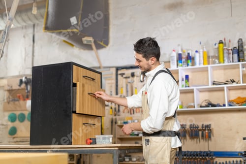 Preview: Furniture Factory, Small-Sized Companies And People Concept - Young Man Working At The Furniture