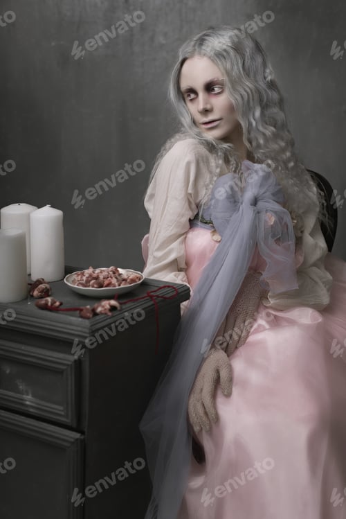 Preview: Dark Halloween Portrait Of Scary Bad Zombie Girl Sitting In A Chair And Collecting Hearts