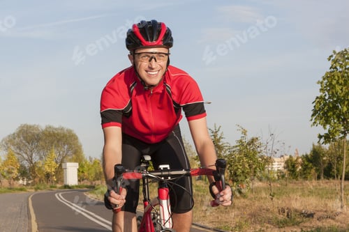 Preview: Cycling Concepts And Ideas. Smiling Caucasian Road Cyclist During Ride On Bike Outdoors. Completely