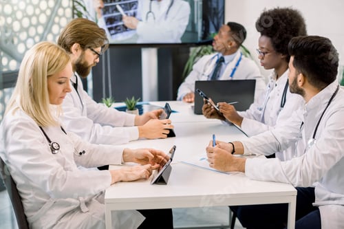 Preview: Professional Team Of Five Multi-Ethnic Medical Doctors Having Video Conference. Medical Specialists