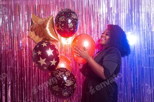 Preview: Portrait Of A Beautiful African American Woman Against Twinkling Background. Birthday Party