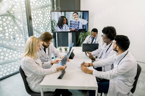 Preview: Team Of Five Diverse Multiethnic Doctors Having Video Conference Meeting In Hospital, Chatting With
