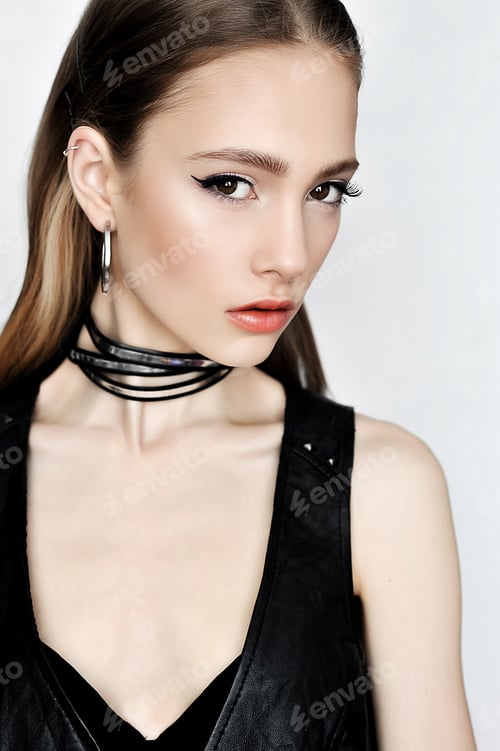 Preview: Punk Rock Style. Fashion Woman Model Face With Glamour Makeup. Perfect Skin, Black Arrows On Eyes