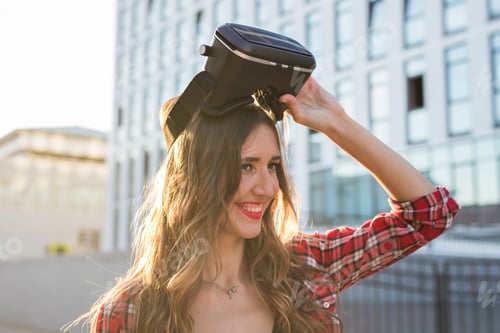 Preview: Beautiful Young Woman Wearing Virtual Reality Headset In An Urban Context