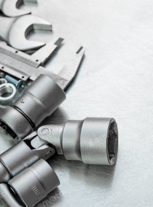 Preview: Metal Tools. Wrench With A Set Of Heads And Other Metal Tools On The Scratched Metal Background.