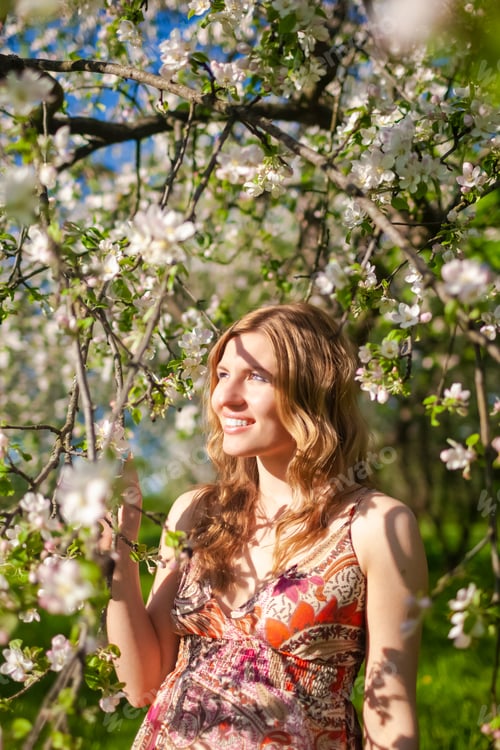Preview: Summertime Concepts. Portrait Of Positive Caucasian Woman With Tree Branches In Garden