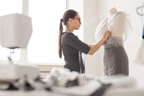 Preview: Dressmaker, Tailor, Fashion And Showroom Concept - Side View Of Female Fashion Designer Measuring