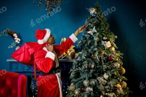Preview: African Santa Claus Stands Near The Christmas Tree. Laughing And Smiling African Male Santa Claus