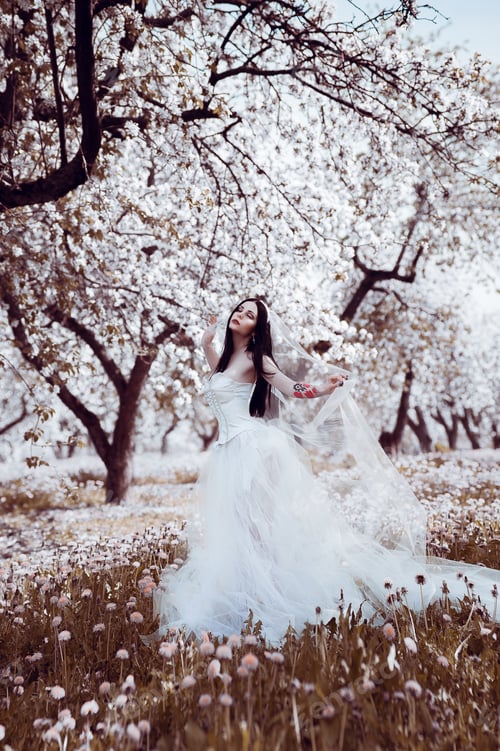 Preview: Portrait Of Young Dark-Haired Woman In The Flowered Garden In The Spring Time. Almond Flowers