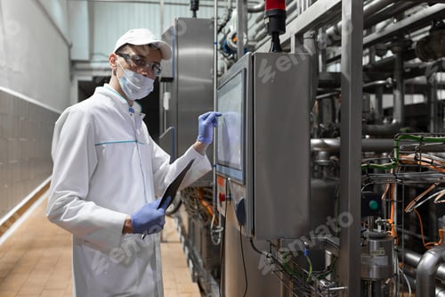 Preview: Technologist Taking Necessary Notes While Standing At Production Department Of Dairy Factory