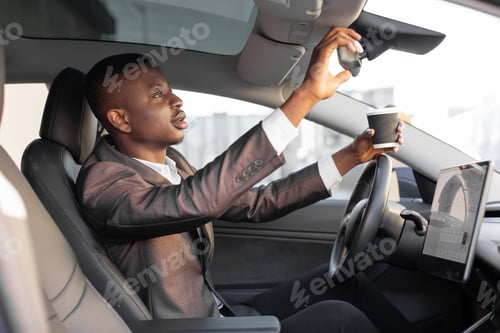 Preview: Break On The Road. Handsome Relaxed African Man In Business Outfit, Sitting In Modern Futuristic
