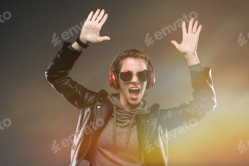 Preview: Cool Girl Is Enjoying Music In Headphones On A Black Background With A Glow Effect