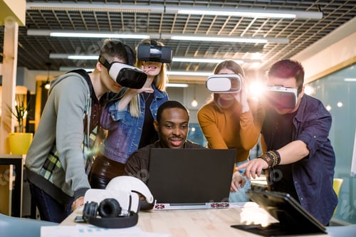 Preview: Group Of Adult Hipsters Coworkers Using Modern Gadgets. Four Business Friends Wearing Vr Goggles