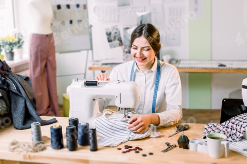 Preview: Closeup Portrait Of Young Woman Seamstress Sitting And Sews On Sewing Machine. Fashion, Sewing