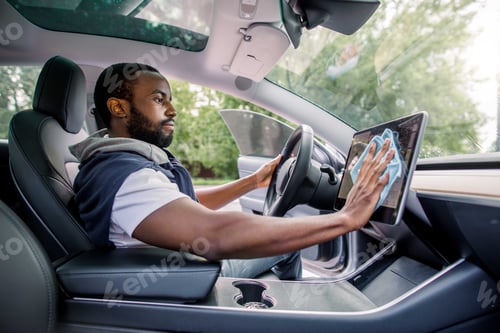 Preview: Cleaning Time, Car Detailing Concept. Portrait Of Young Handsome African Man With Beard Sitting