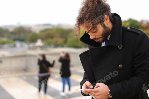 Preview: Half Italian And Nigerian Man Making Call With Modern Smartphone Close To Eiffel Tower In Slow
