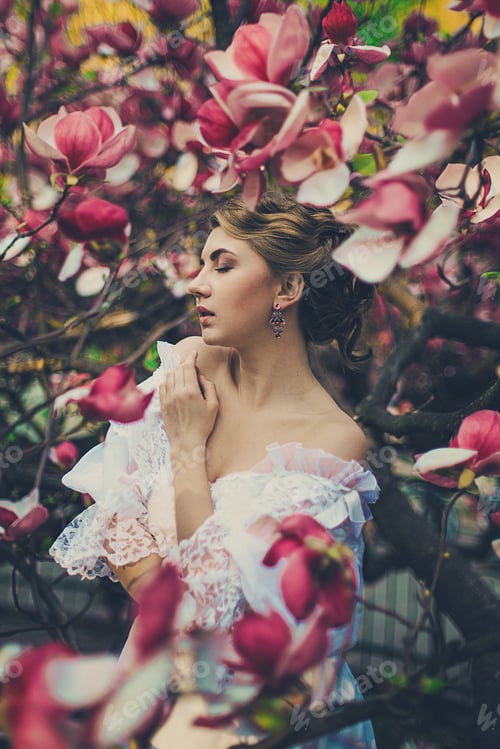 Preview: Young Caucasian Woman Among Pink Magnolia Flowers. Concept Of Floral Spring Inspiration And Beauty.