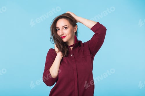 Preview: Confident Girl Smiling To Camera. Portrait Of Woman Over Blue Background
