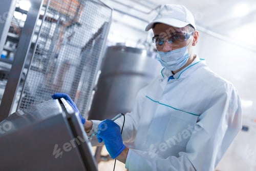 Preview: Man In The Mask And The Robe Works With The Monitor To The Factory Of Dairy Products