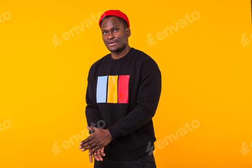 Preview: Youth Street Fashion Concept - Portrait Of Confident Sexy Black Man In Stylish Sweatshirt On Yellow