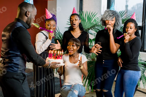 Preview: African Teenagers With Party Horns And A Cake Celebrating A Birthday