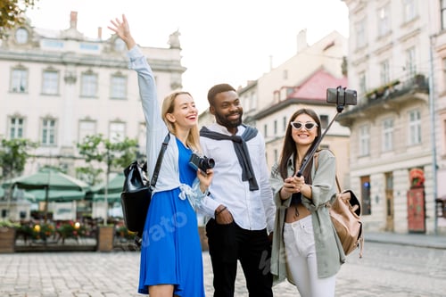 Preview: Excited Cheerful Mix Raced Friends Enjoying Walking Outdoors In European City. Man And Two Women