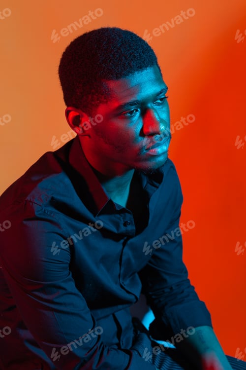 Preview: Dark Neon Portrait Of Young Man Wearing In Shirt. Red And Blue Light. Technology