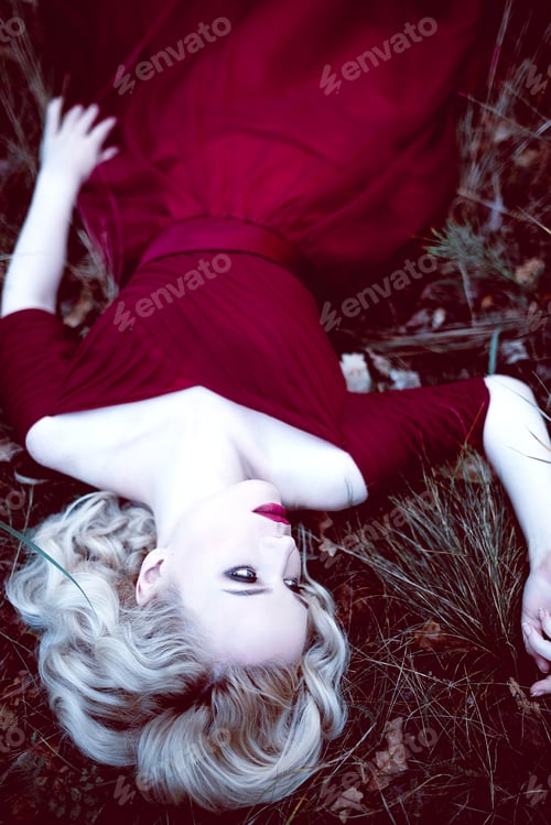 Preview: Fashion Gorgeous Young Blonde Woman In Beautiful Red Dress In A Fairy-Tale Forest. Magic Atmosphere