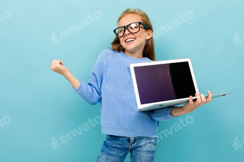 Preview: Joyful European Girl Holding A Computer In Her Hands With Mockup On A Light Blue Background