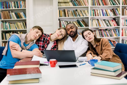 Preview: Tired Four Mixed Race Students Having A Lot To Study In A Library, Leaning Each Other And Sleeping