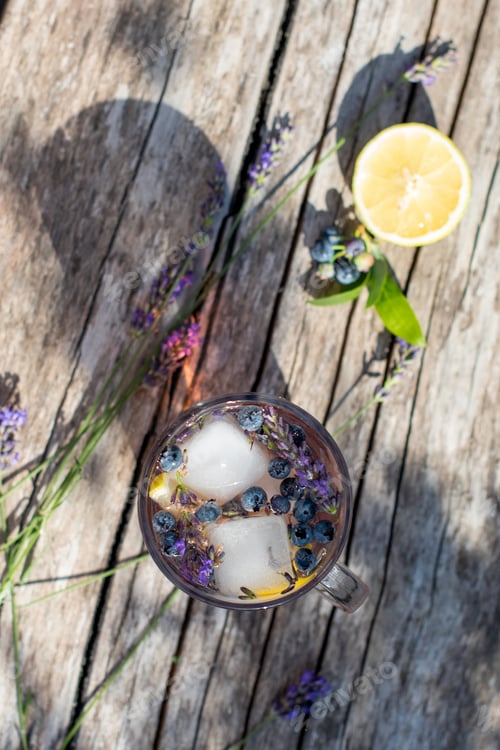 Preview: cold refreshing tea with blueberry, lime and lavender on a hot summer day