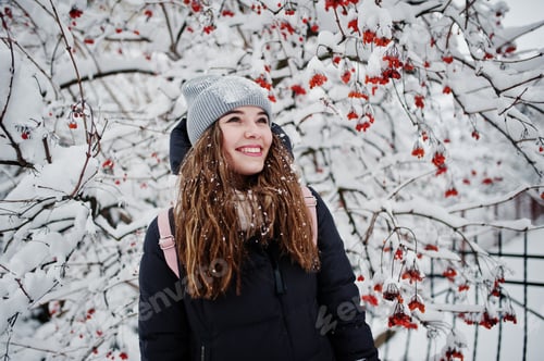 Preview: Portrait of girl at winter snowy day near snow covered trees.