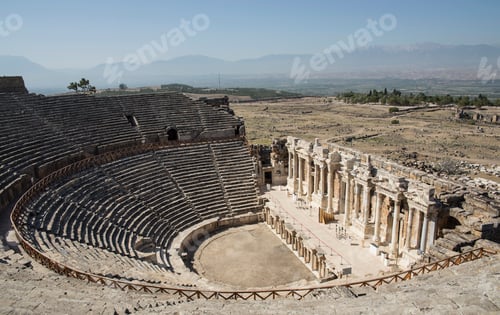 Preview: Ancient amphitheater basking in the sun with a scenic mountain backdrop