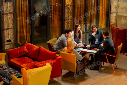 Preview: top shot in large beautiful hall office employees sitting on yellow chairs discuss a deal