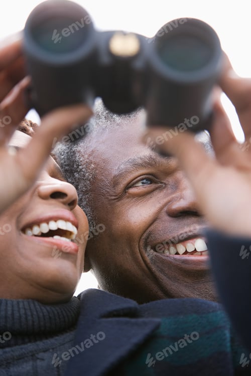 Preview: One couple looking through binoculars