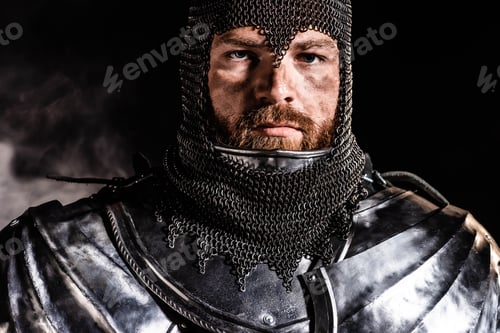 Preview: handsome knight in armor looking at camera on black background