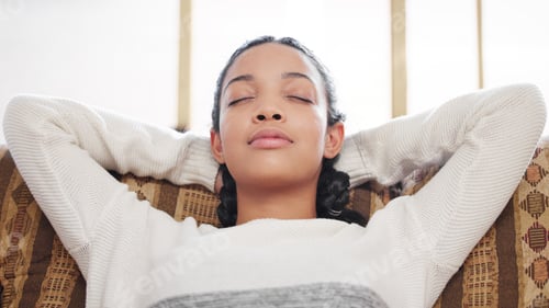Preview: Not everything needs your immediate attention. Shot of a young woman relaxing on the sofa at home.
