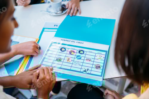 Preview: University exchange students organizing weekly schedule for summer course abroad